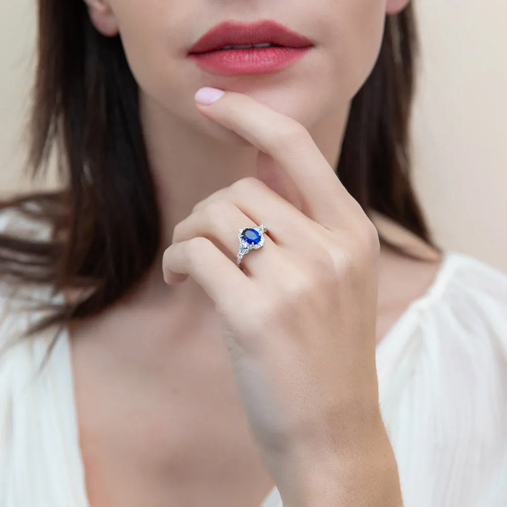 Halo Simulated Blue Sapphire Oval CZ Ring Set in Sterling Silver