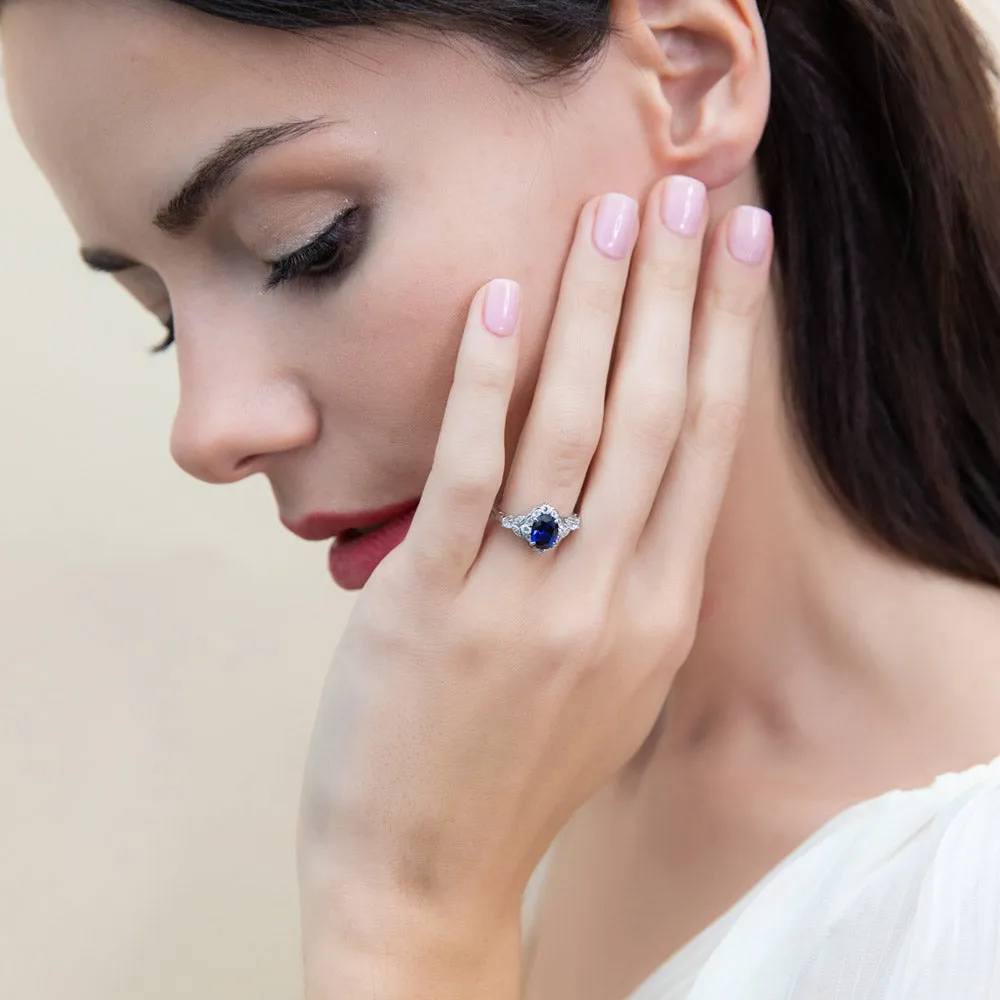 Halo Simulated Blue Sapphire Oval CZ Ring Set in Sterling Silver